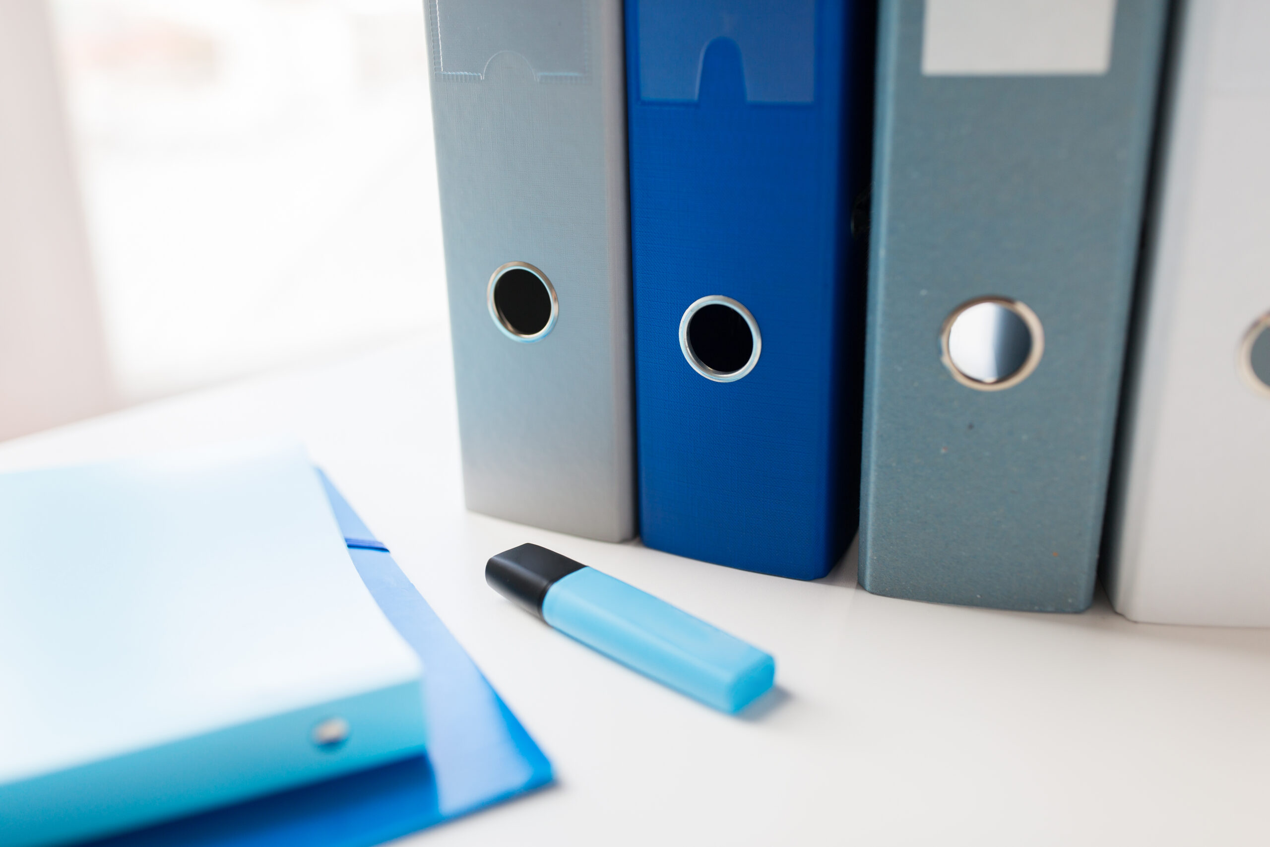 close up of ring binders and files on office table