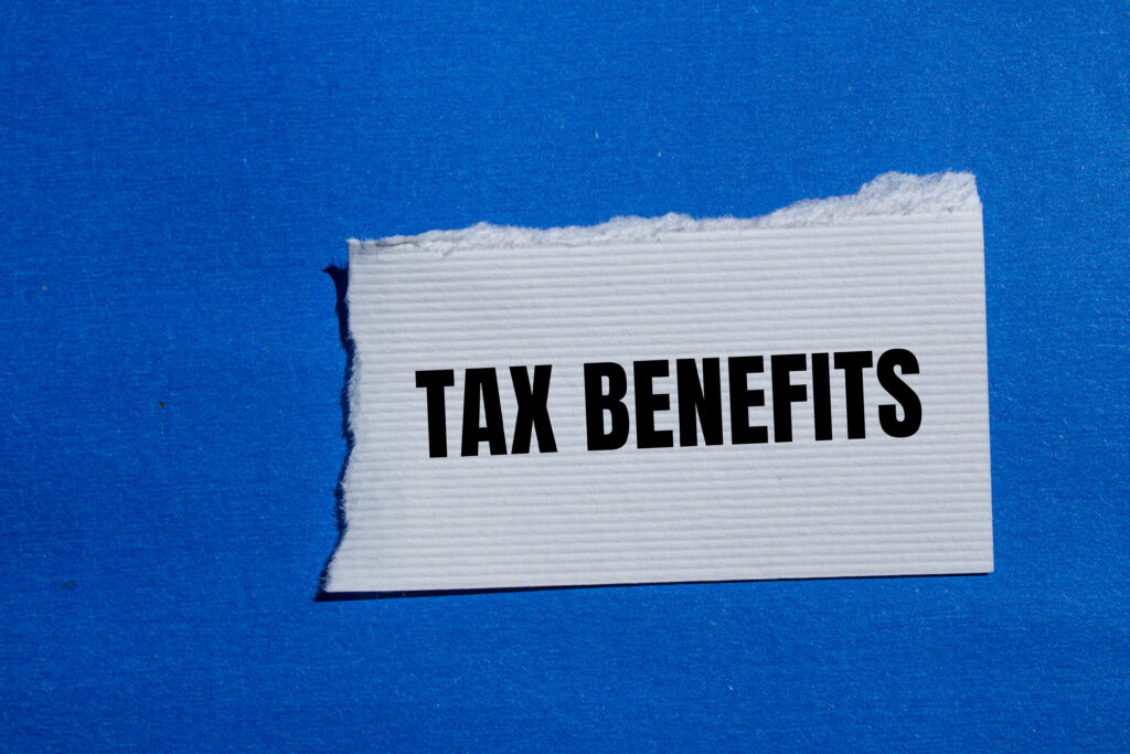 tax-benefits-words-written-ripped-white-paper-piece-with-blue-background